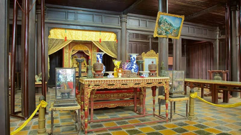 Tomb of Emperor Tu Duc: Admission to UNESCO Complex of Hue Monuments A traditional ornate room with a golden altar, decorative vases, and intricate furniture.