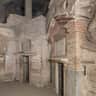 Catacombs of San Sebastiano: Entry Ticket + Guided Tour Ancient stone and brick structures with detailed arches and doorways in a historical site. No people present.
