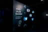 Thermenmuseum Dark exhibition panel with "400 Jaar Baden" text alongside six small display screens showing various water-themed visuals.
